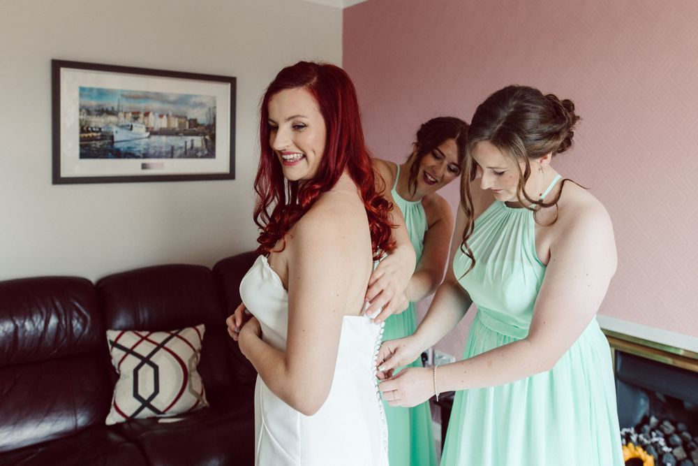 Wedding preparation scene with mint green bridesmaid dresses.