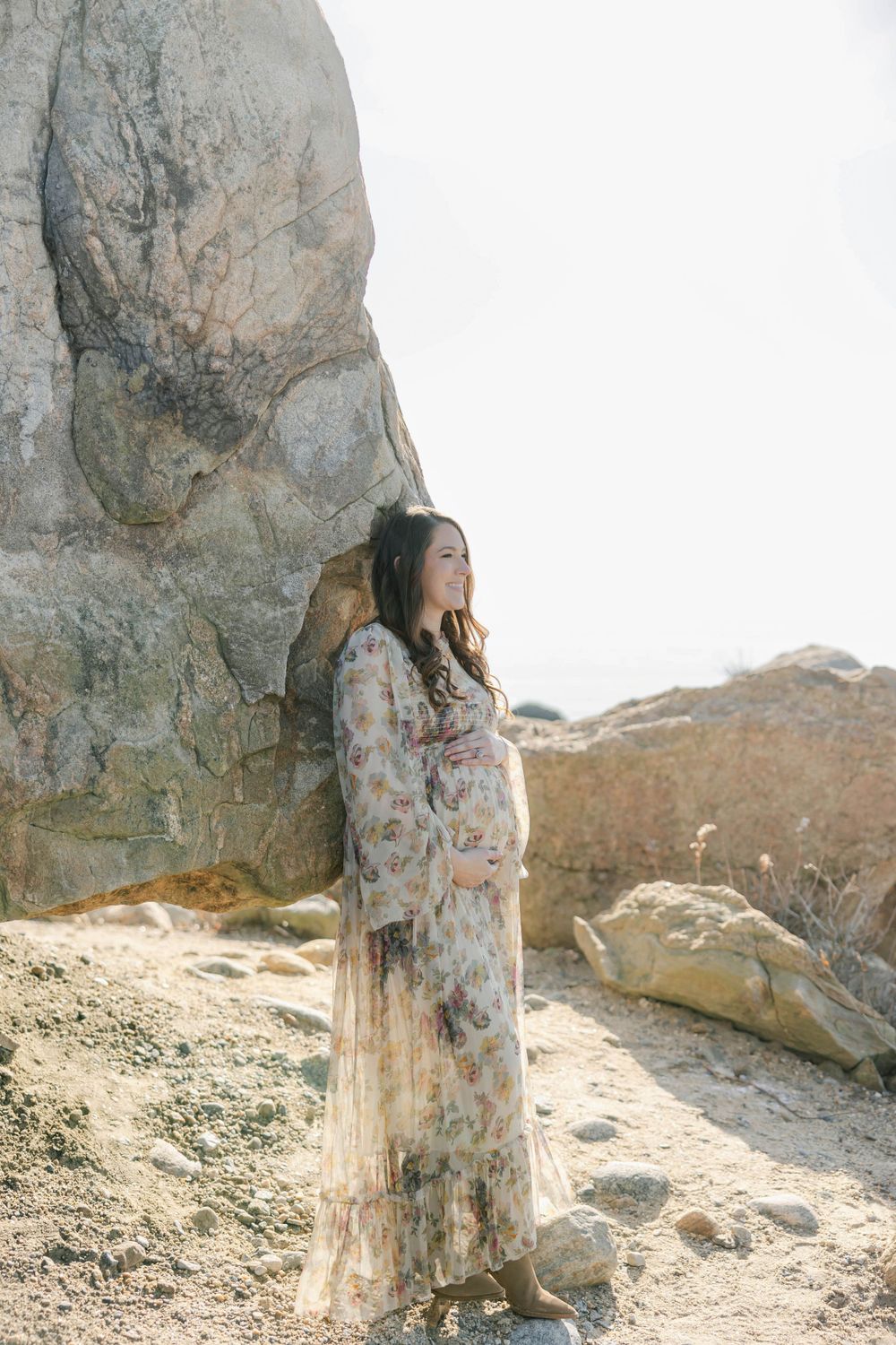 Pregnant mom on rock at the beach. Newborn photography session in Connecticut studio by Ashley Nielsen Studio.
