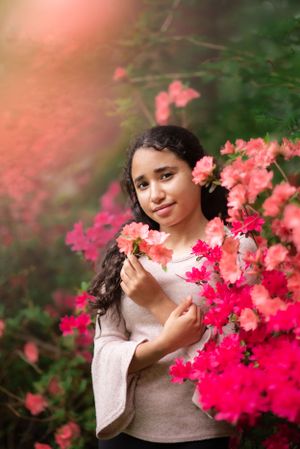 Child portrait of a girl among vibrant pink flowers in soft dreamy lighting in Holmdel Park NJ