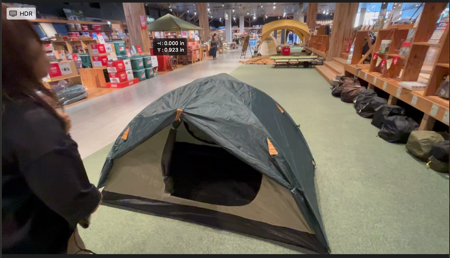 Camping tents set up in an indoor retail display area.