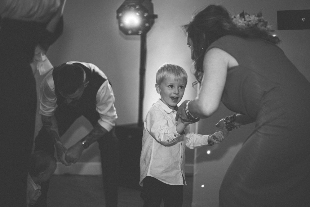 Black and white candid photos capturing moments during a wedding reception.