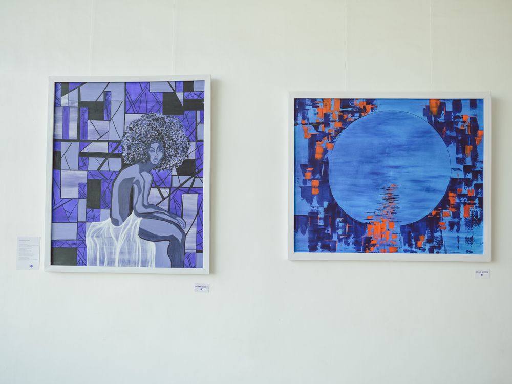 Two modern art pieces with blue geometric designs and abstract patterns displayed side by side.