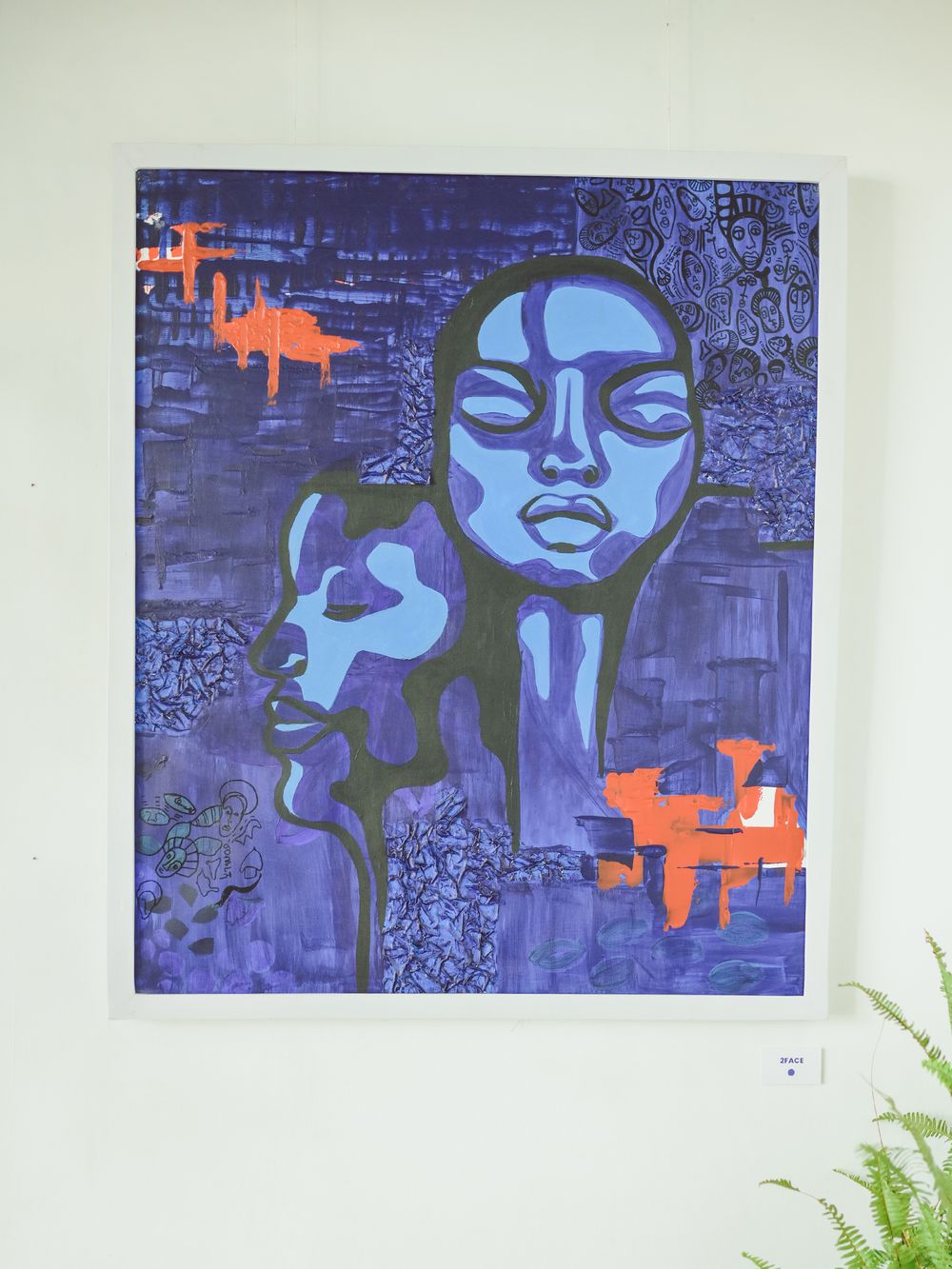 Modern blue and orange abstract portrait artwork with geometric patterns.
