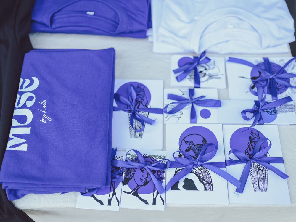 Purple and white gift packages arranged neatly with blue ribbons and bows.