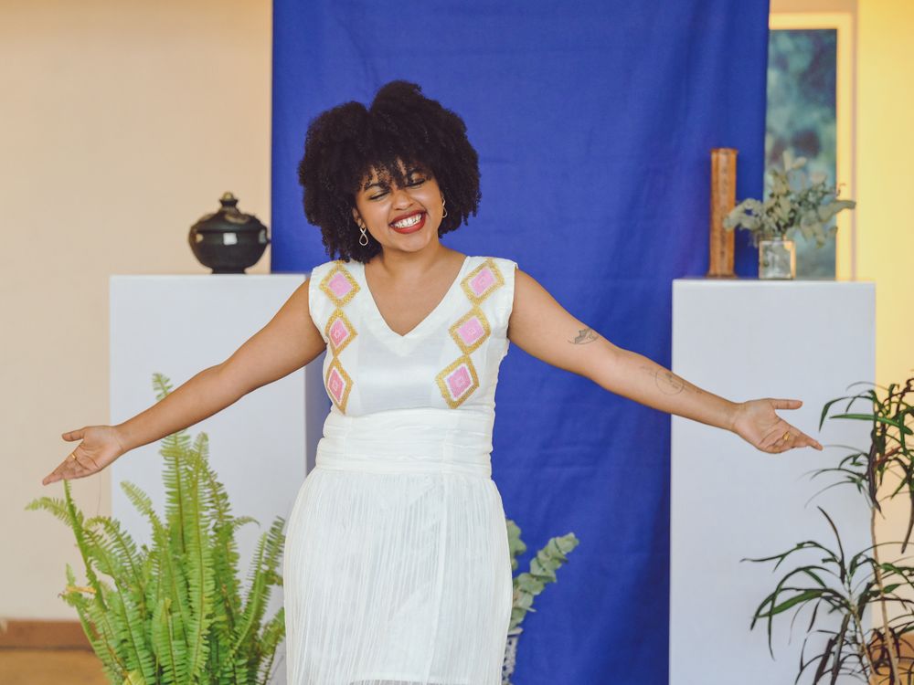 A joyful scene at an art gallery with a bright blue backdrop.