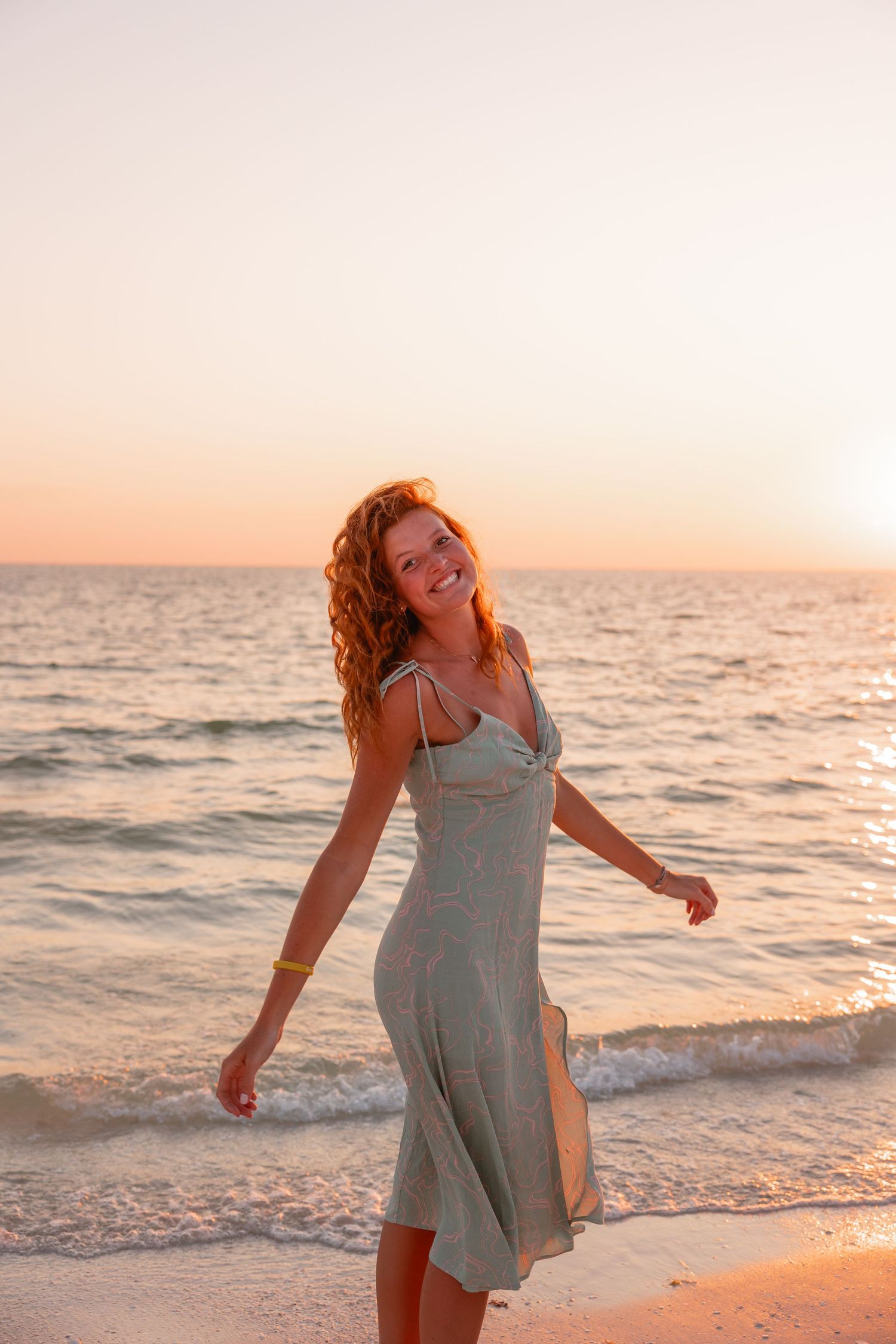 Girl dancing on the coast of Wrightsville Beach while having her picture taken
