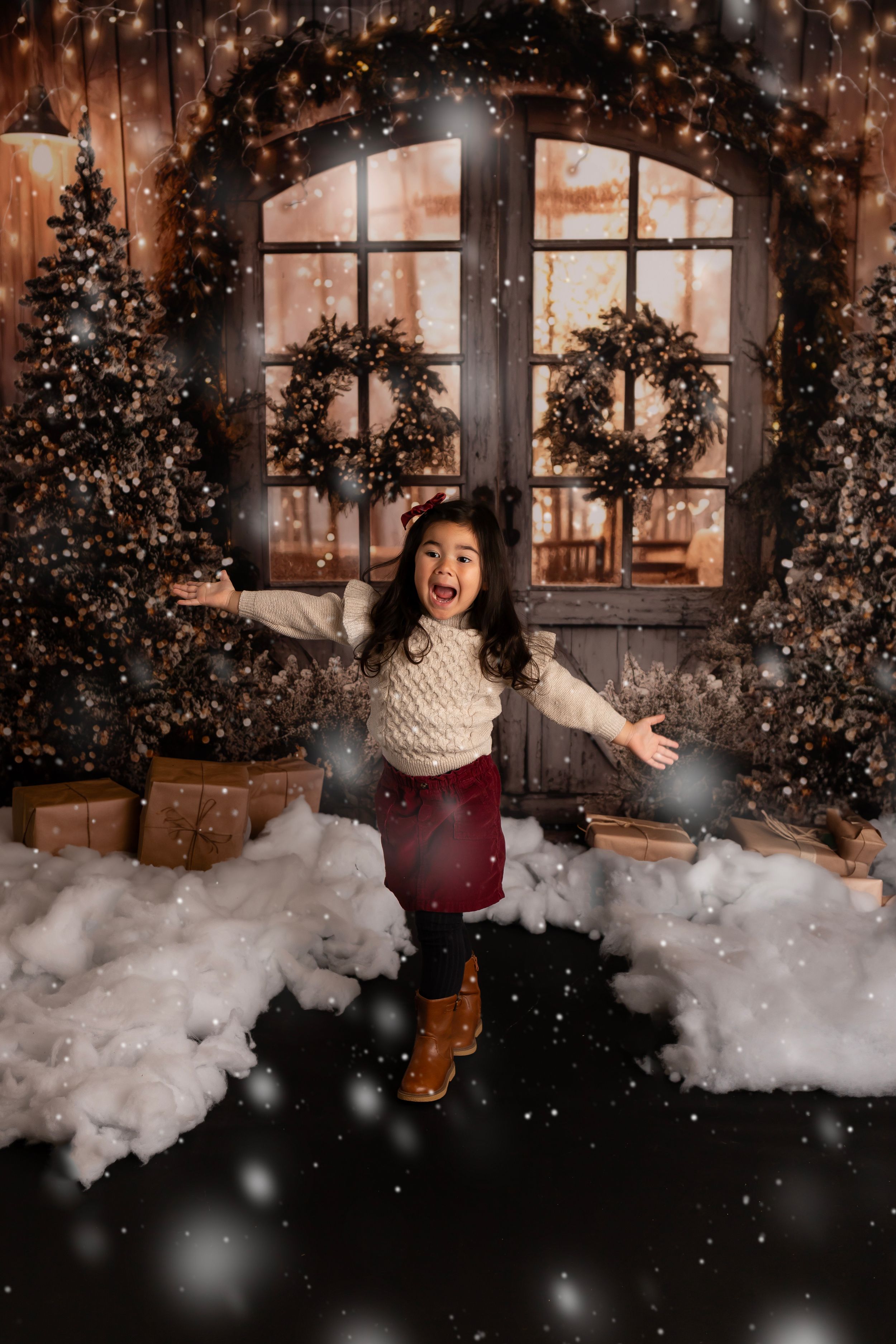 Joyful winter scene with falling snow, Christmas wreaths, and decorative lights.