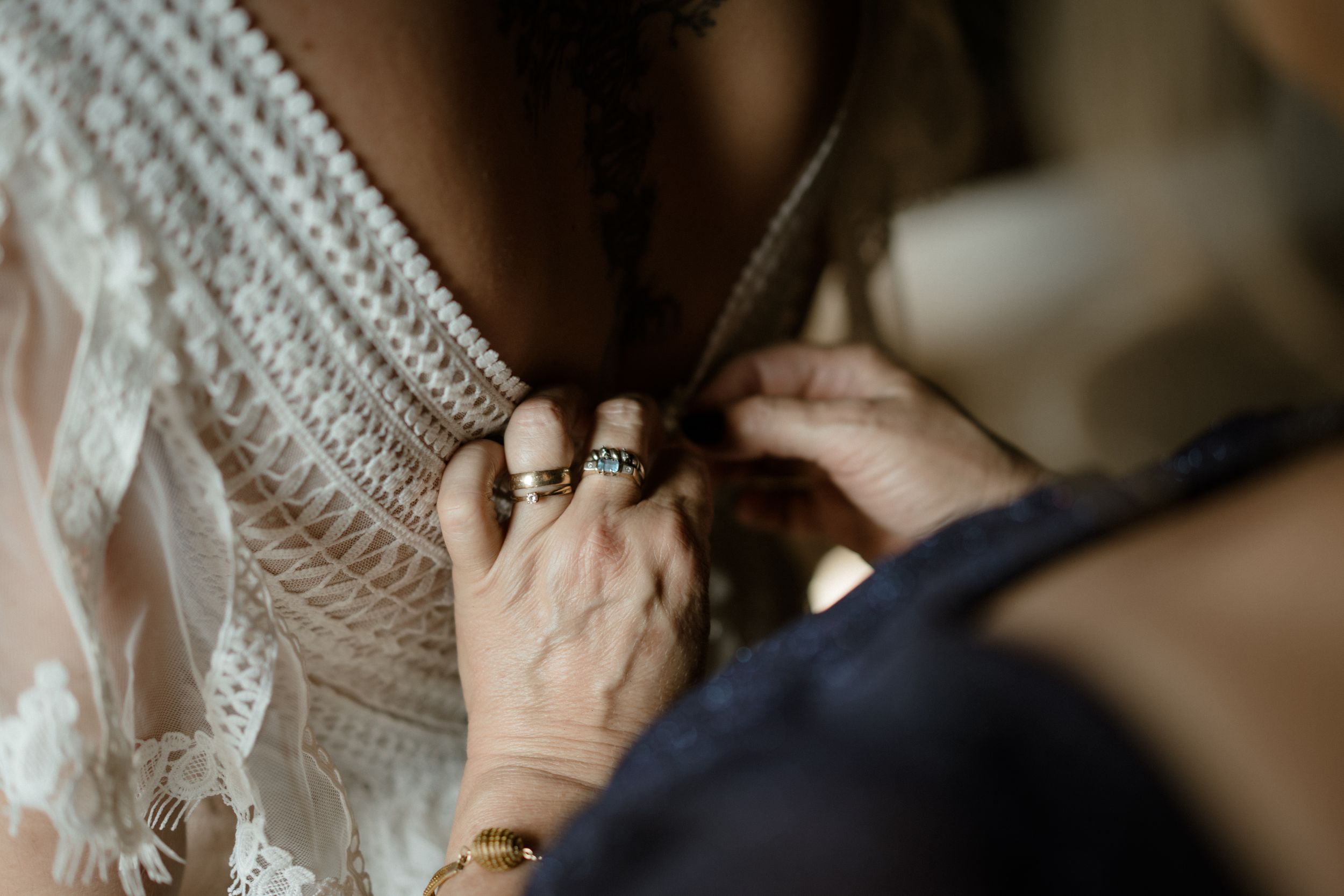 Close-up detail of intricate lace wedding dress with delicate beading.