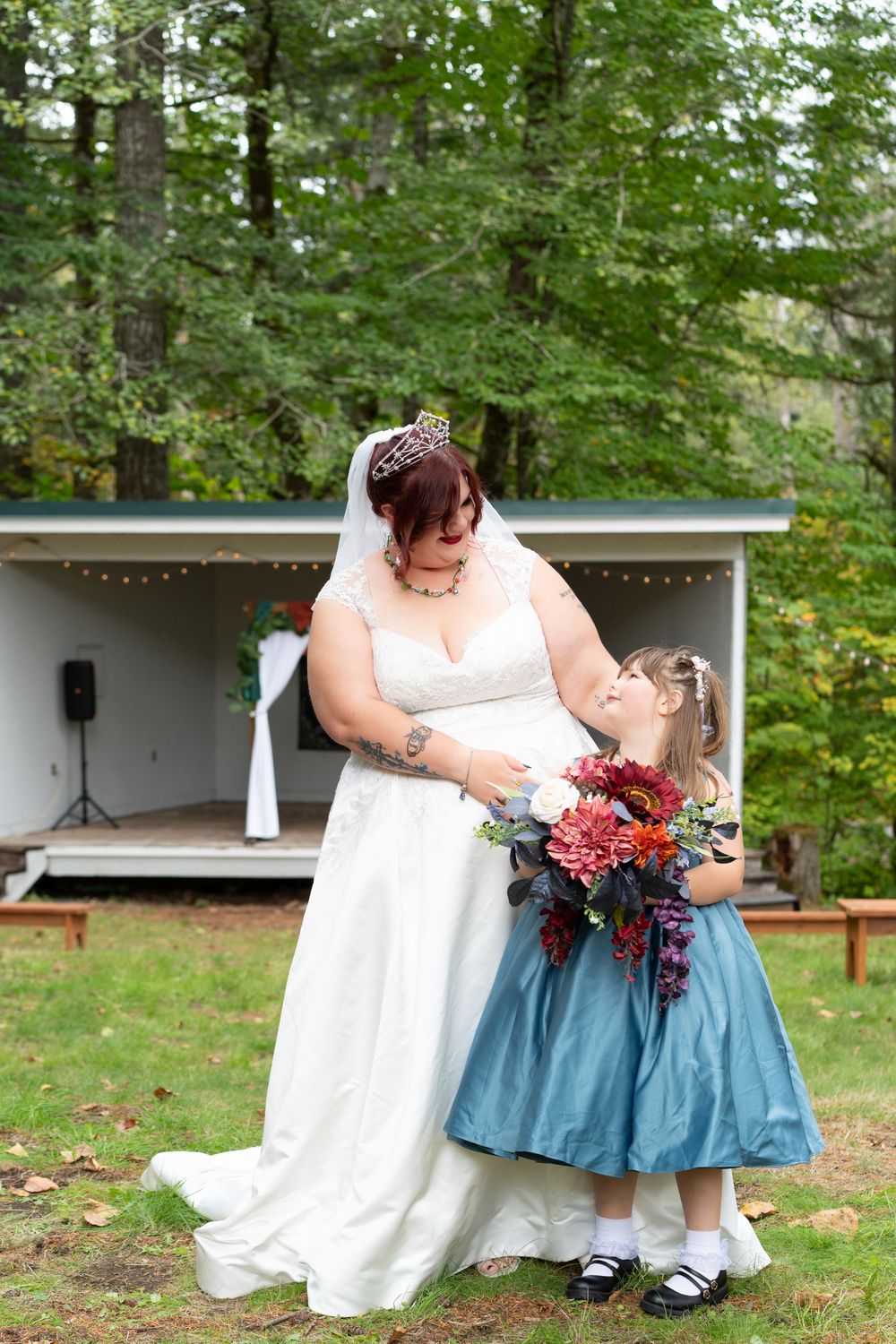 A bride in a white wedding dress and her daughter. Captured by Savvy Photography - Seattle Wedding Photographer