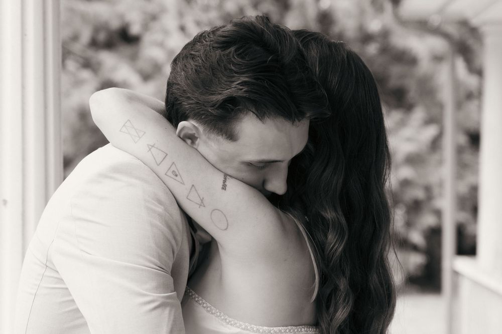 Bride and Groom Embrace in a black and white photo, captured by Savvy Photography - Seattle Wedding Photographer