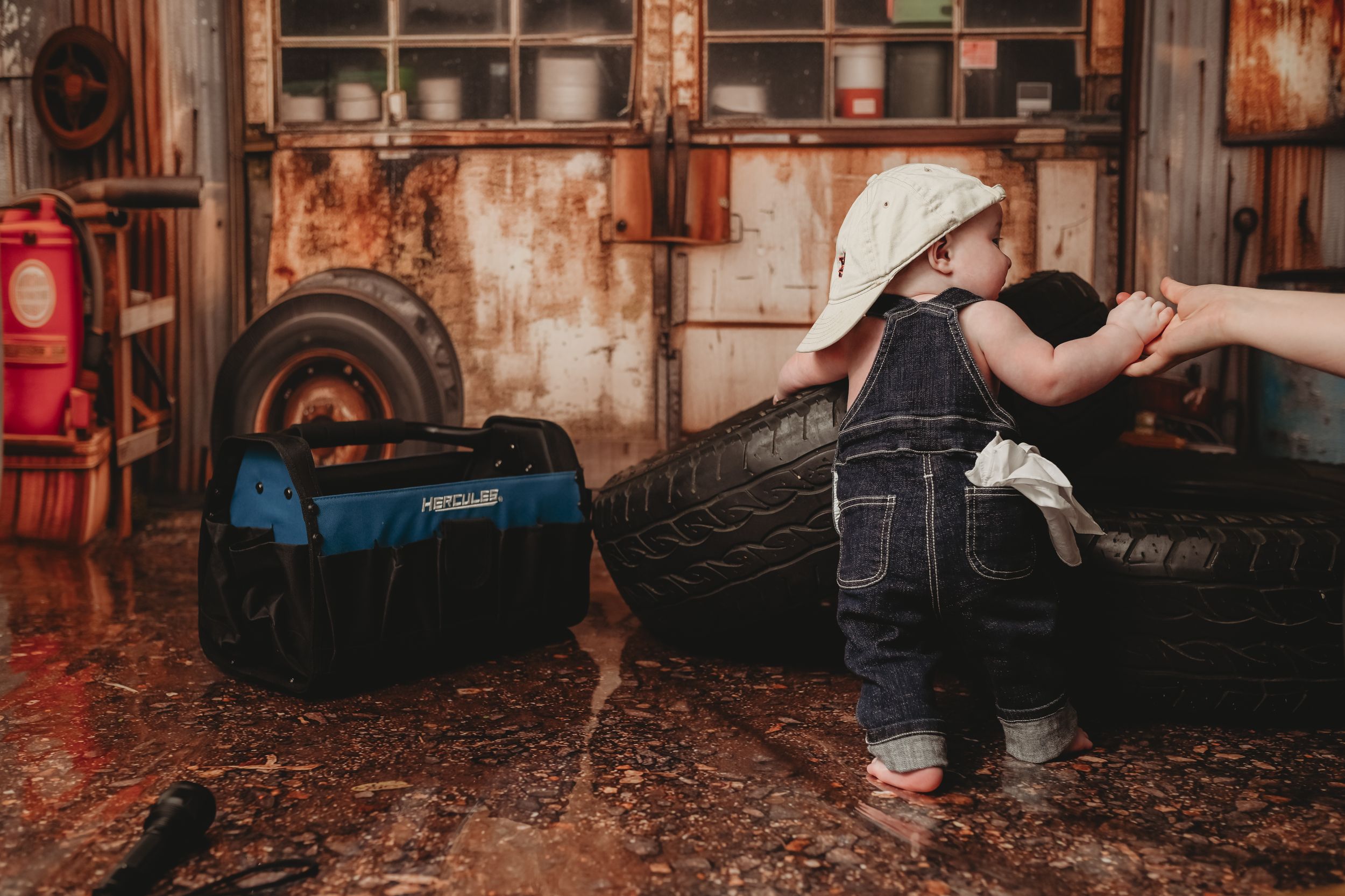 Baby crawling sequence on dark wooden floor with vintage backdrop.