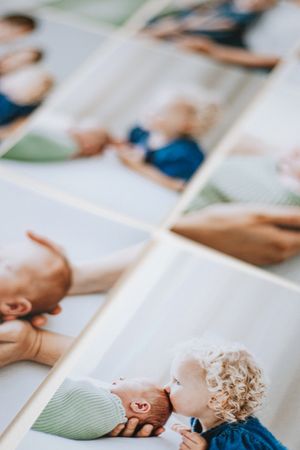 Multiple printed photographs spread out showing babies and small children in casual poses and portraits.
