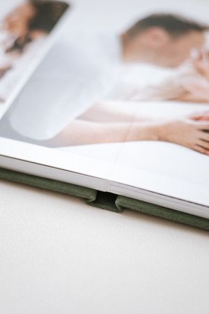 Close-up view of an open photo album or book with blurred images visible on its pages.
