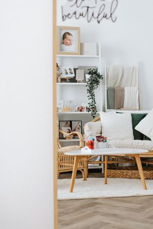 rattan studio furniture photographed through the perspective of large mirror for a newborn photoshoot in Mansfield, Nottingham