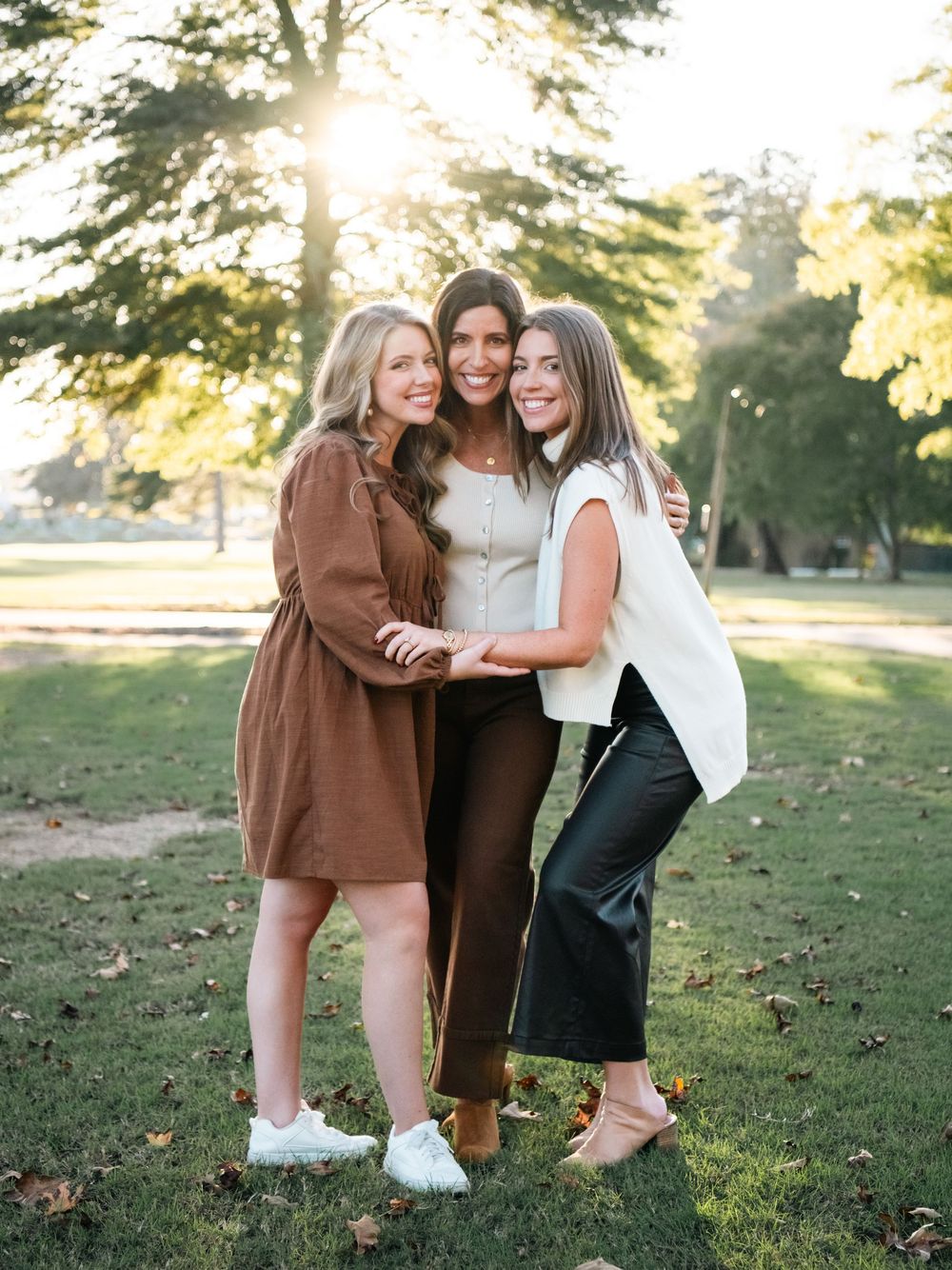 Casual group photos taken in a sunny park setting with natural backlighting.