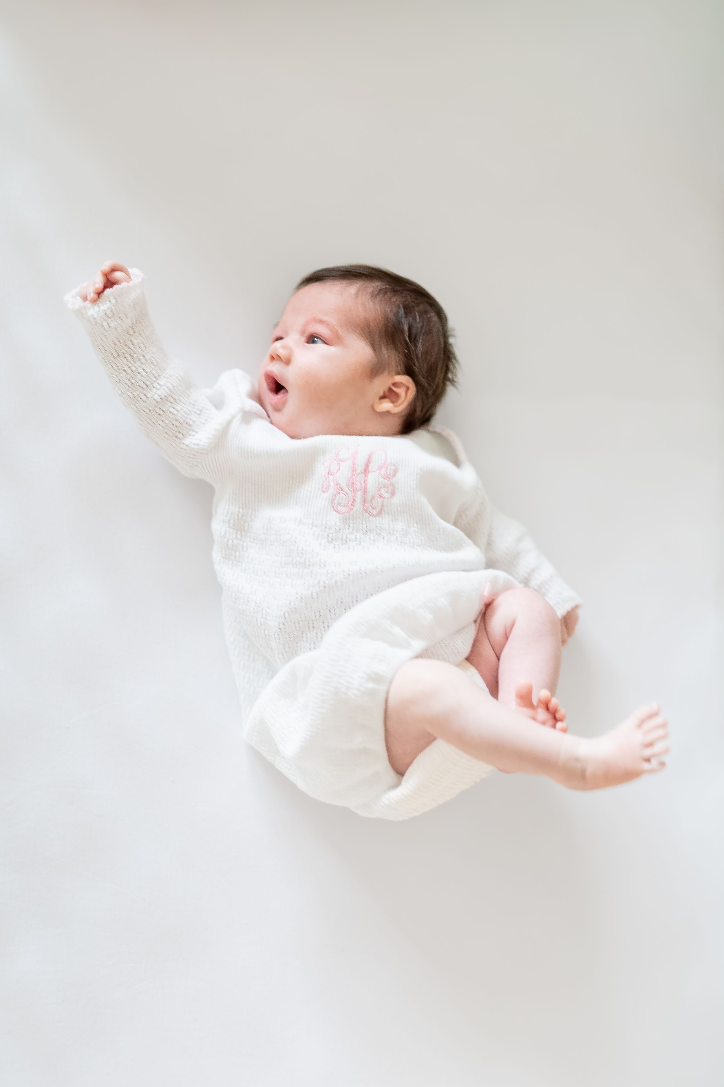 baby girl in the crib newborn photos