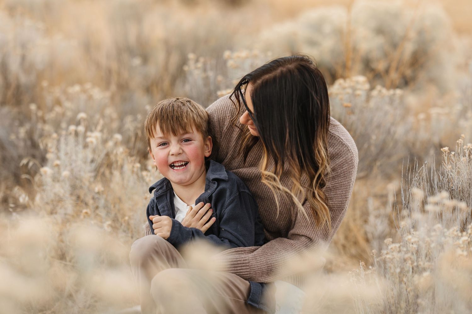 A series of candid family photos showing joyful moments in an outdoor autumn setting with golden grass.