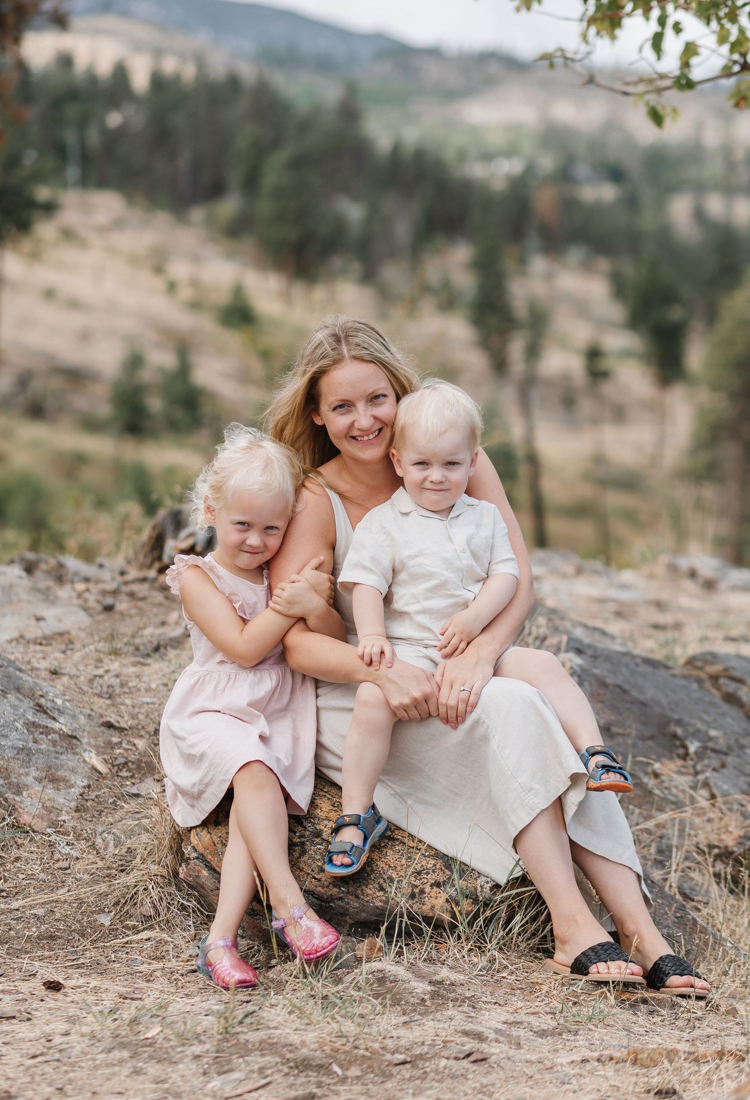 A series of intimate outdoor family photos showing tender moments between parent and children on a rocky hillside.