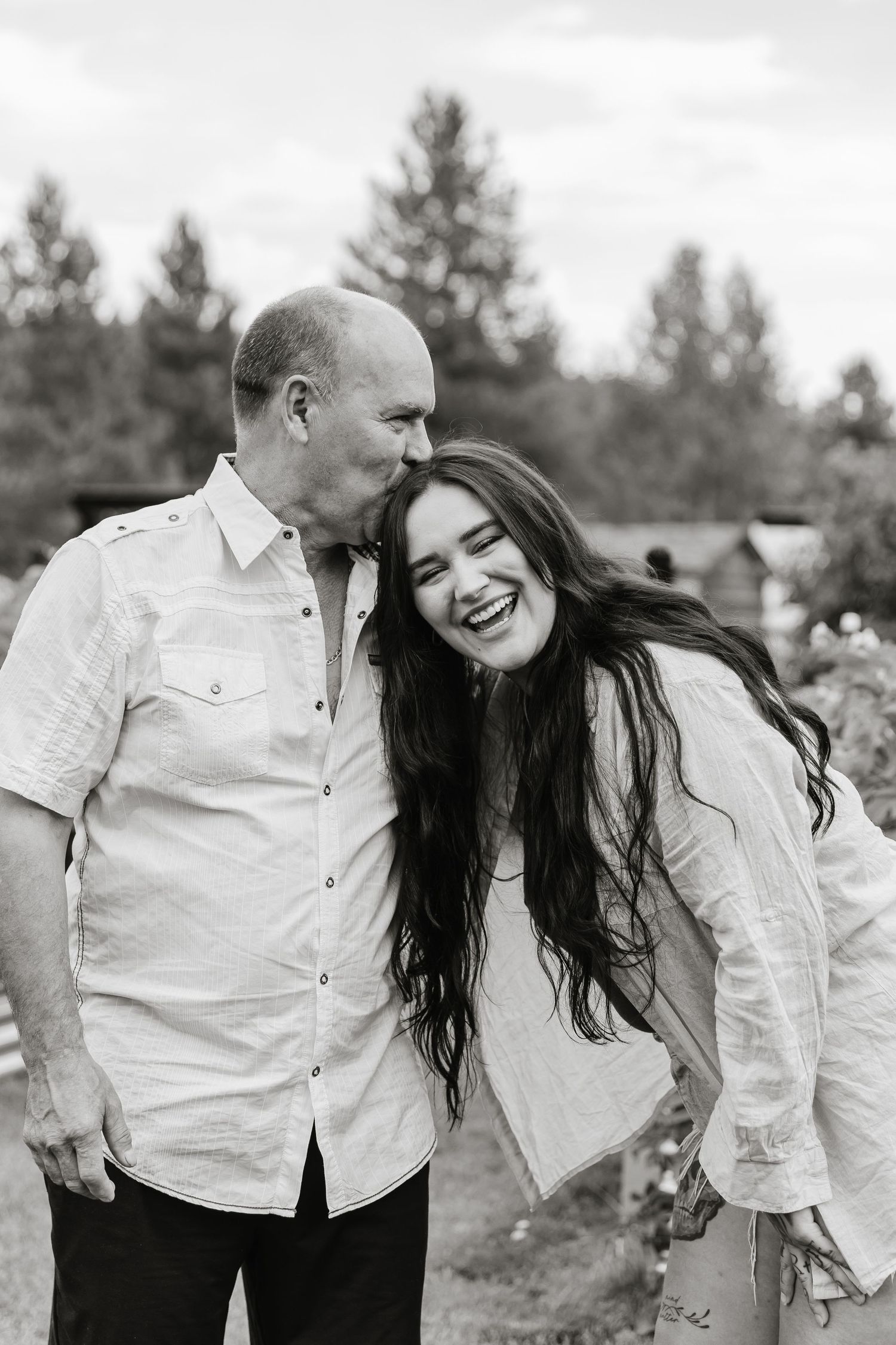 A joyful black and white series of candid moments captured outdoors against a natural backdrop.