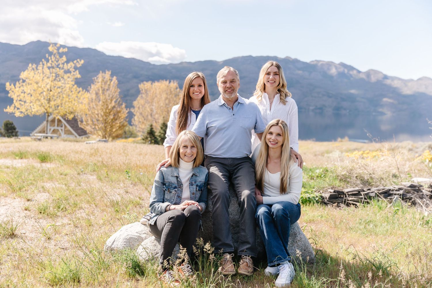 Family portrait session with mountain backdrop on a sunny afternoon in West Kelowna at sanctuary gardens