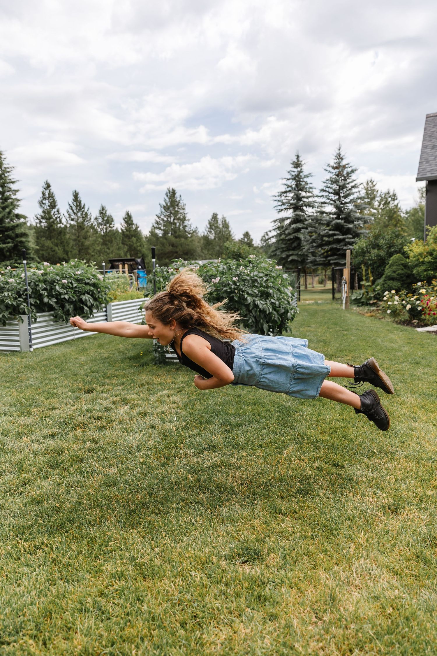 A sequence of photos shows someone falling forward onto a grassy lawn on a cloudy summer day.