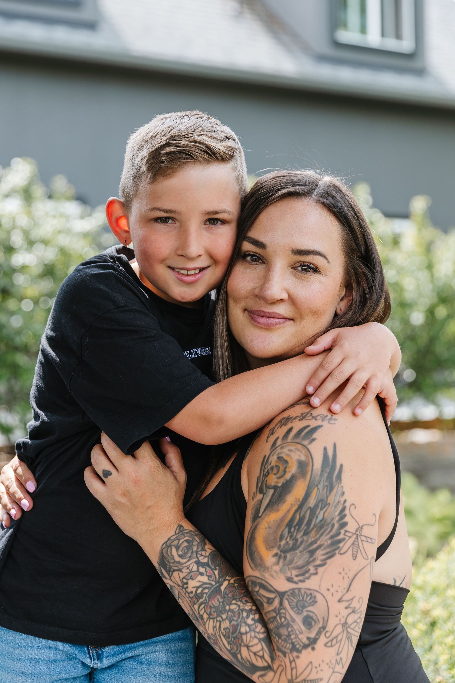 A series of candid outdoor photos showing playful embraces and tattoo art in natural lighting.