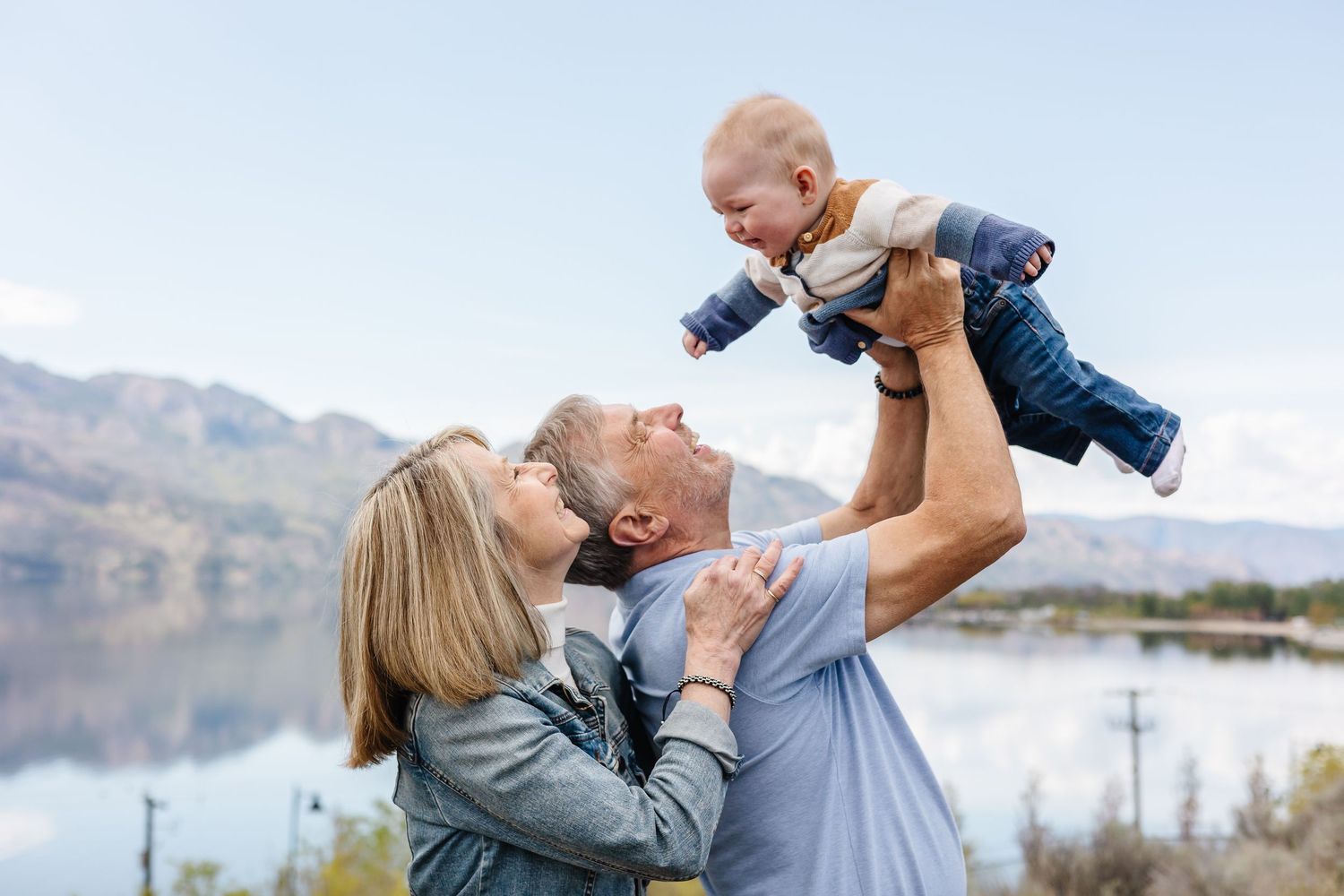 Playful candid family moments captured in a sunny wildflower field at sanctuary gardens in West Kelowna