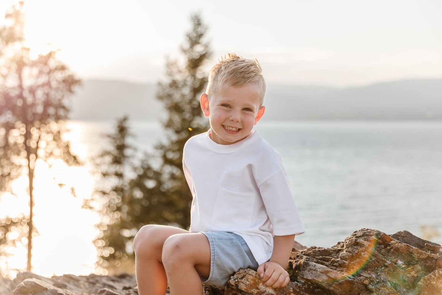 Child portrait for a family photoshoot outdoor with mountain and okanagan lake in background in Kelowna at Bertram creek park