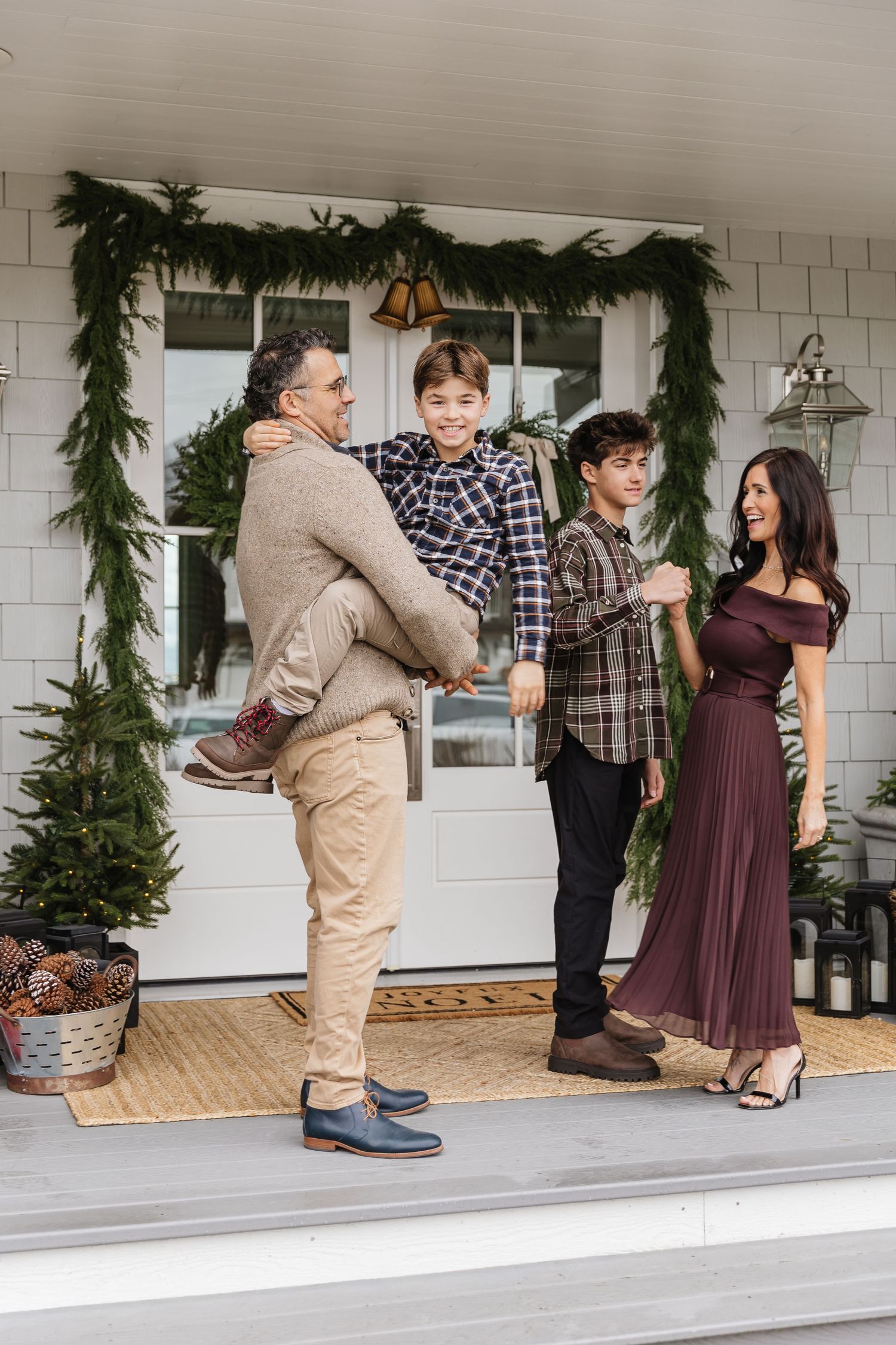 Three sequential photos show a couple dancing on a white porch decorated with evergreen garland for the holidays.