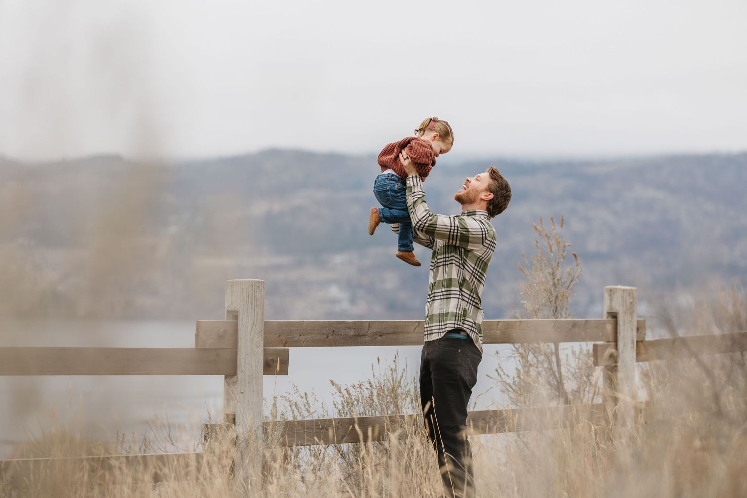 father and daughter candid playful session at Knox mountain park in kelowna bc for family photos