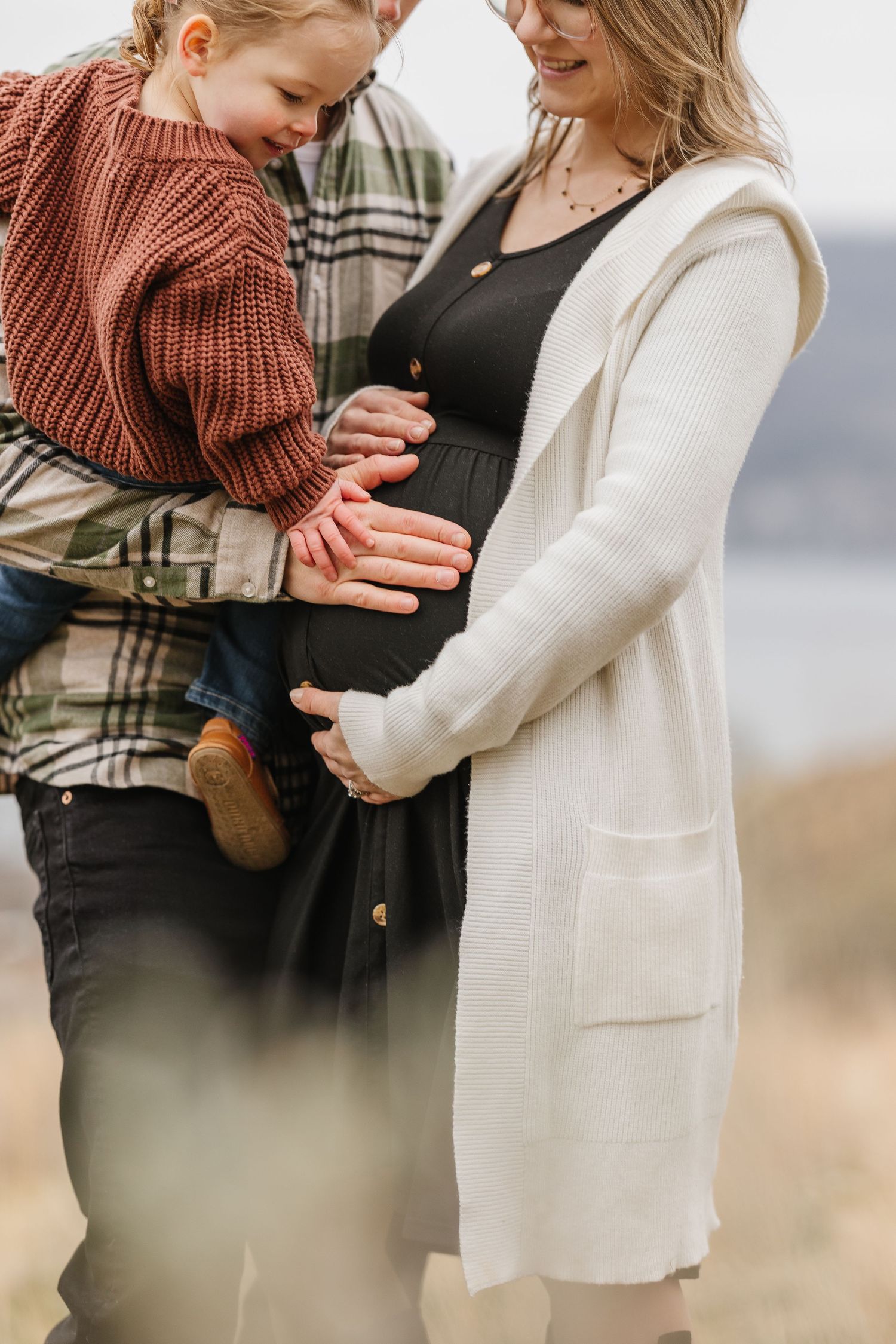 Candid maternity session with close up shots of baby and belly at Knox mountain park in Kelowna BC