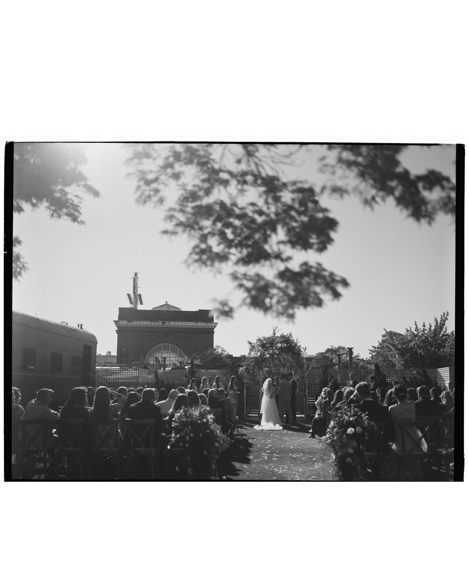 Panoramic black and white view of outdoor wedding ceremony with guests seated.
Film, Authentic, Cinematic photographer, Film Photo