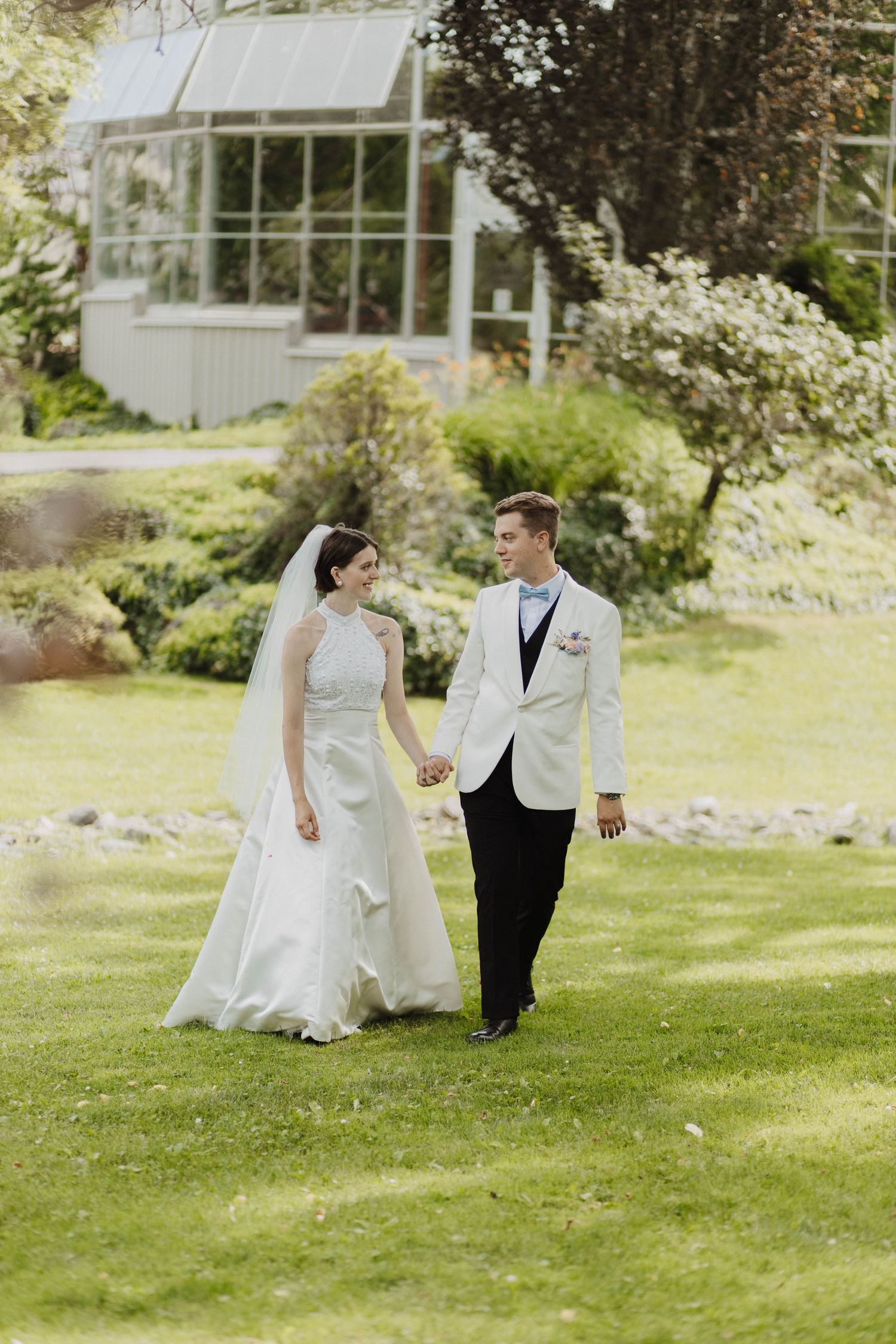 Overhead view of a couple sharing a romantic moment on a chevron patterned floor with floral bouquet.