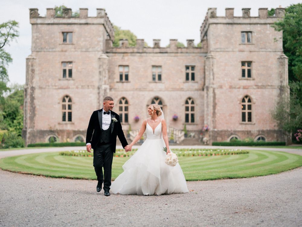 Stone castle wedding venue with elegant architecture provides stunning backdrop for ceremony.