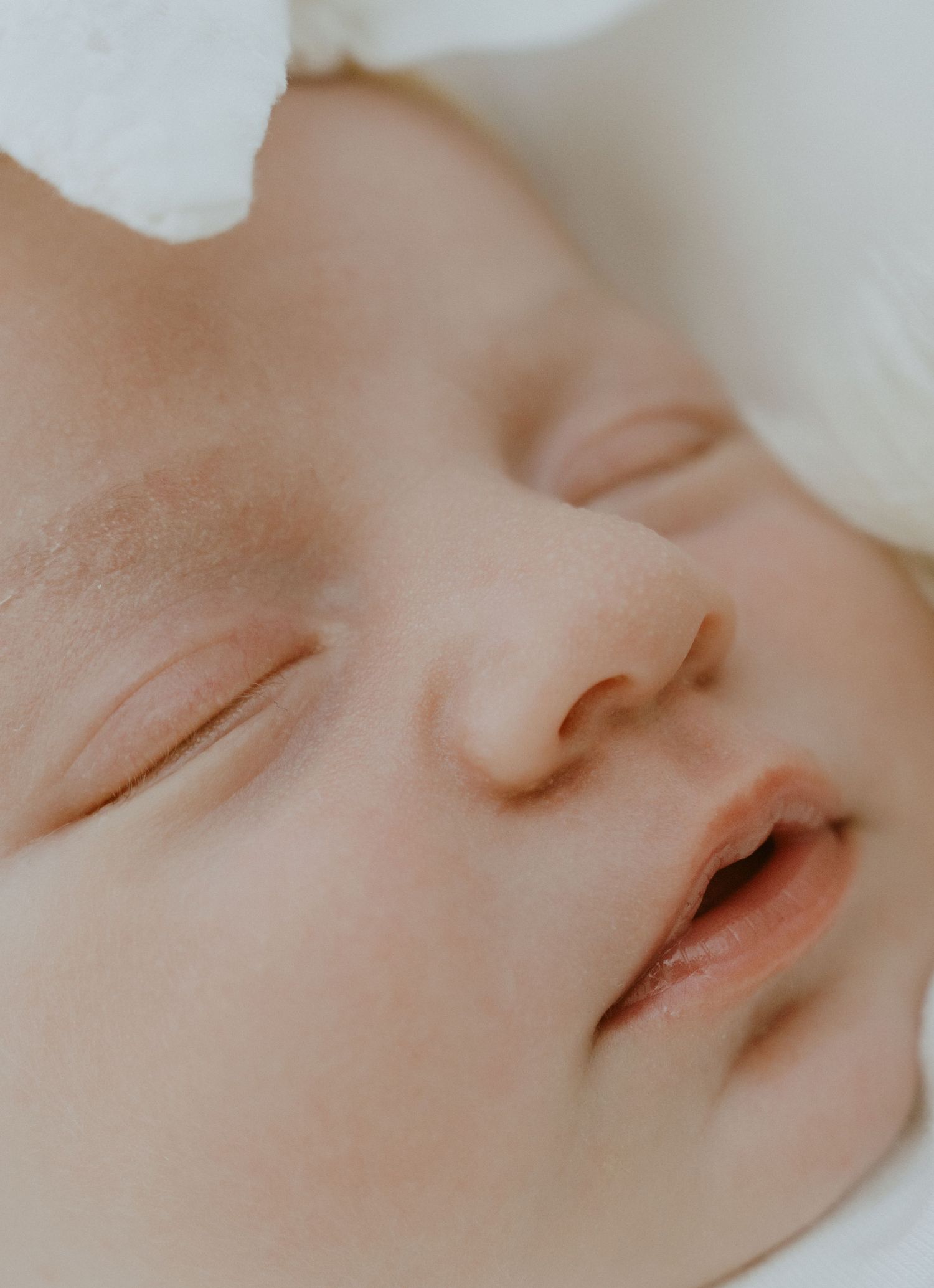 Extreme close-up of a sleeping baby's peaceful face.