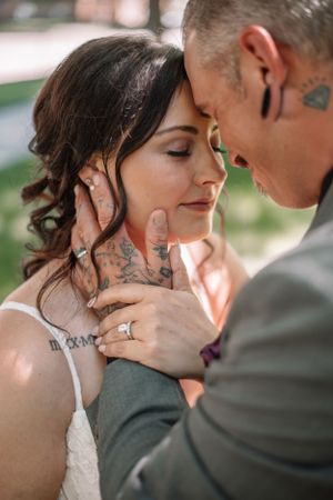 Intimate close-up of couple sharing tender moment with hands touching face.