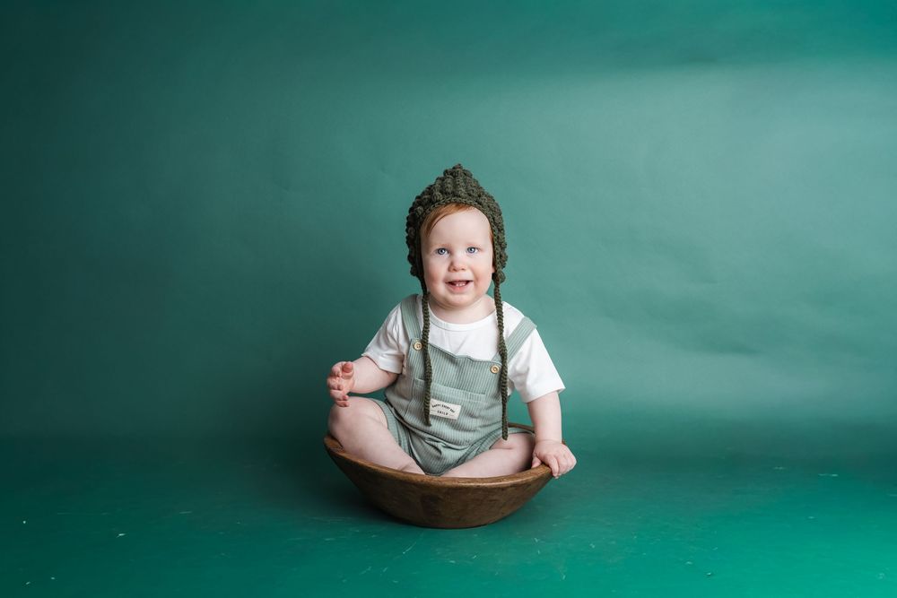 A creative portrait series with teal background showing someone emerging and submerging in different poses.