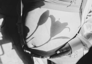 Close-up black and white artistic photograph showing dramatic shadows cast on a curved surface.