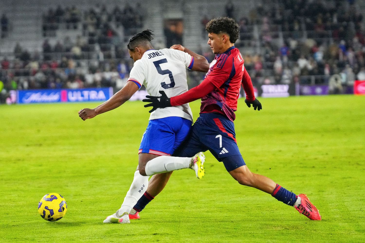 Soccer players compete for the ball during a professional match.