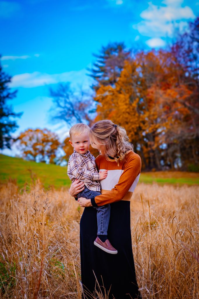 beautiful image of mother and son with brilliant blue sky
