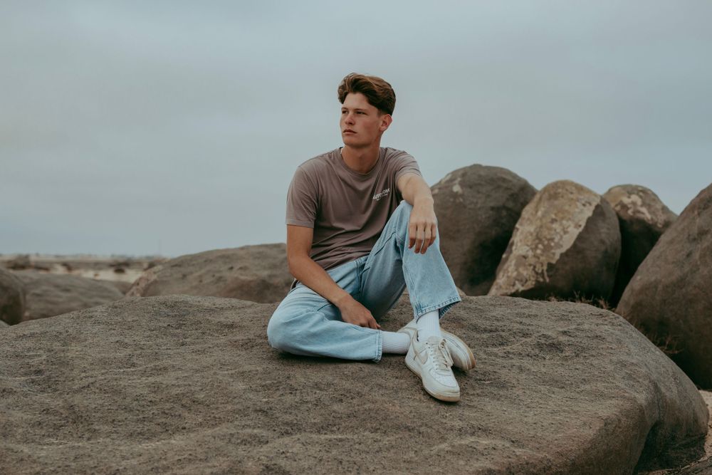 A handsome young man posing for a photoshoot in the Namib Desert,