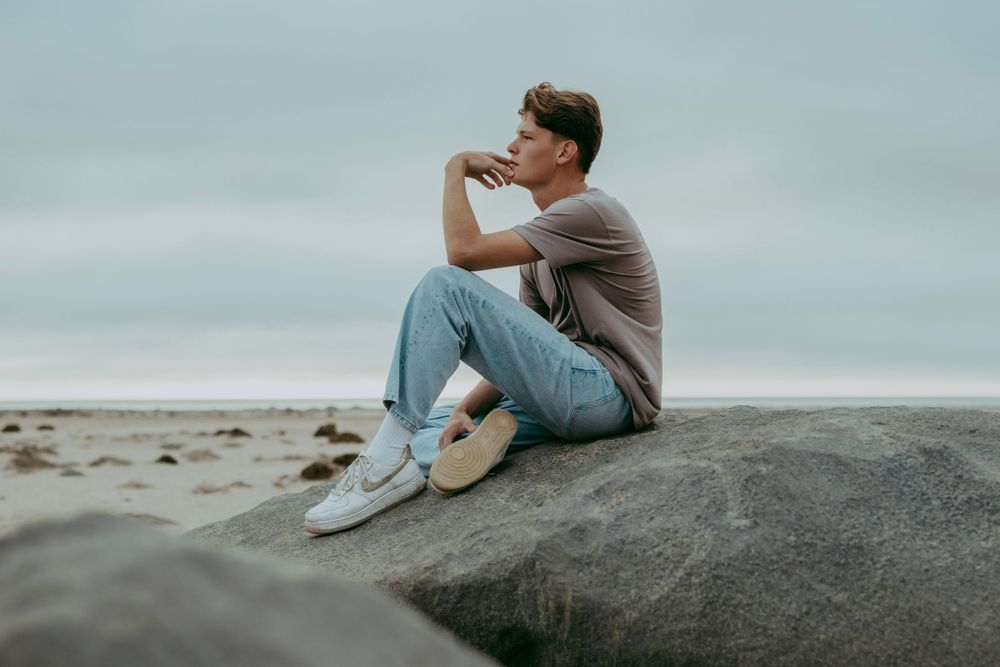A handsome young man posing for a photoshoot in the Namib Desert,