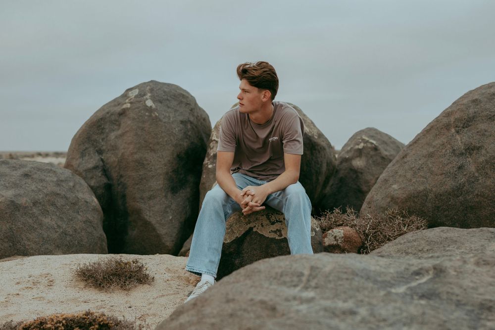 A handsome young man posing for a photoshoot in the Namib Desert,