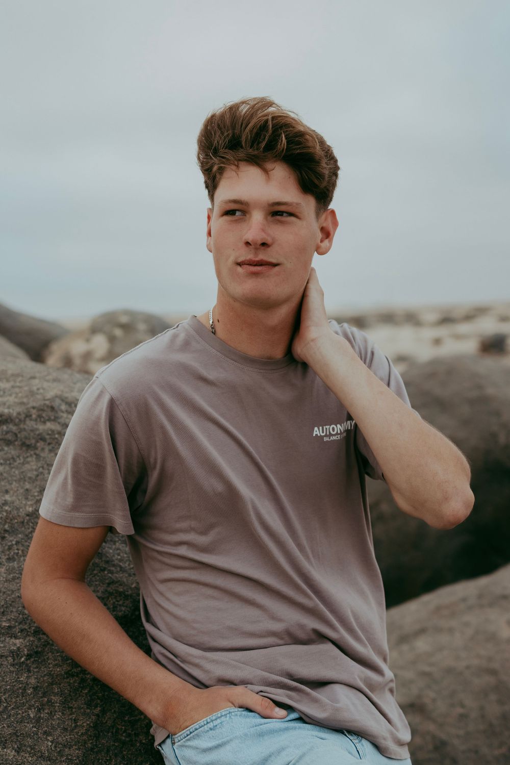 A handsome young man posing for a photoshoot in the Namib Desert,