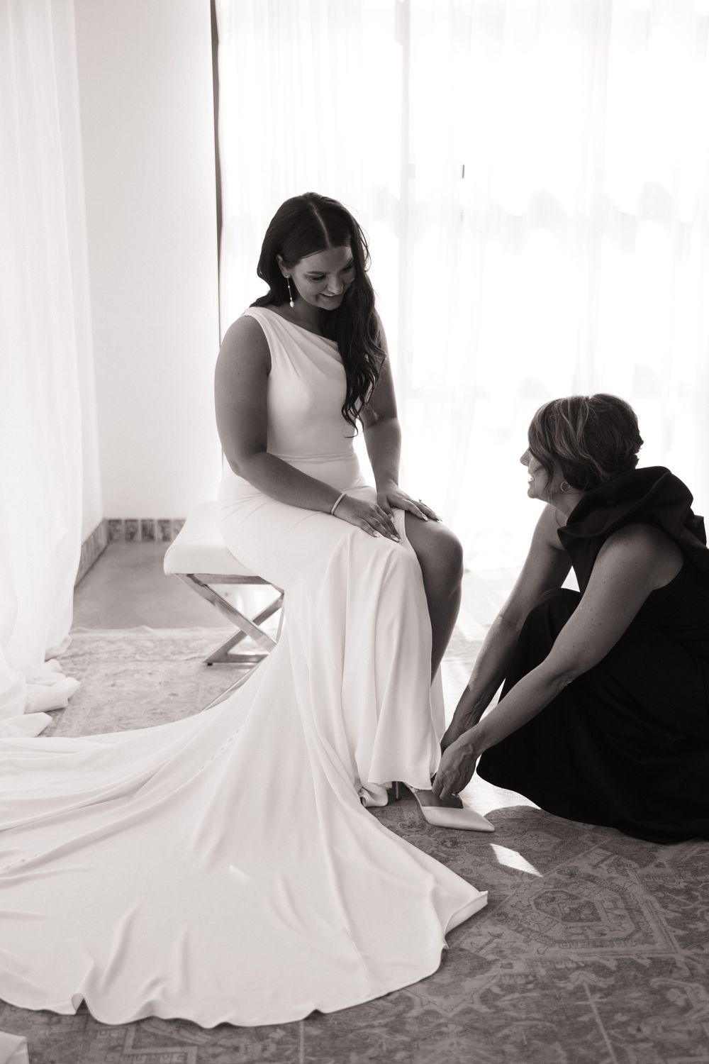 Candid moment of wedding dress fitting and preparation.