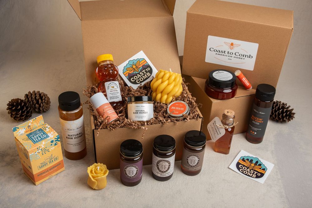 Memphis Product photography shot of selection of honey and honey products arranged in and around gift boxes.