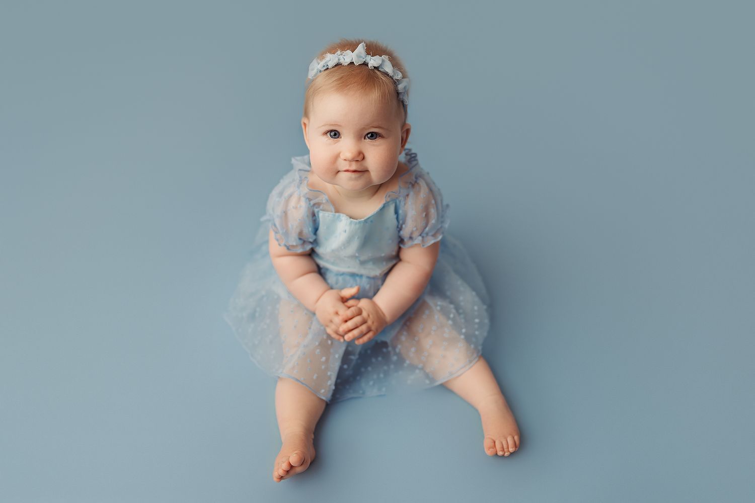 baby girl dress in blue at her sitter session in tulsa oklahoma