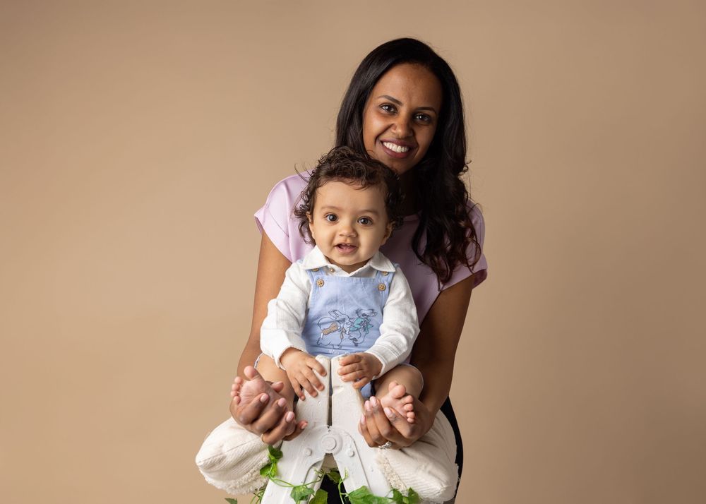 A progression of candid family moments captured against a neutral beige backdrop during a portrait photography session.