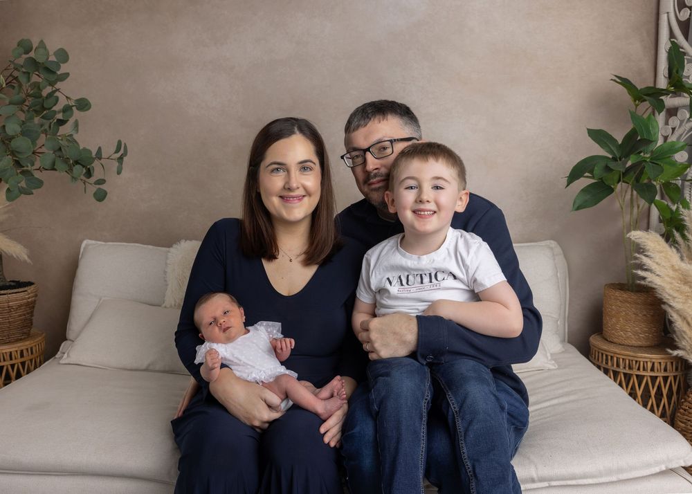 A series of family portraits showing loving moments between parents and children on a couch with indoor plants in the background.