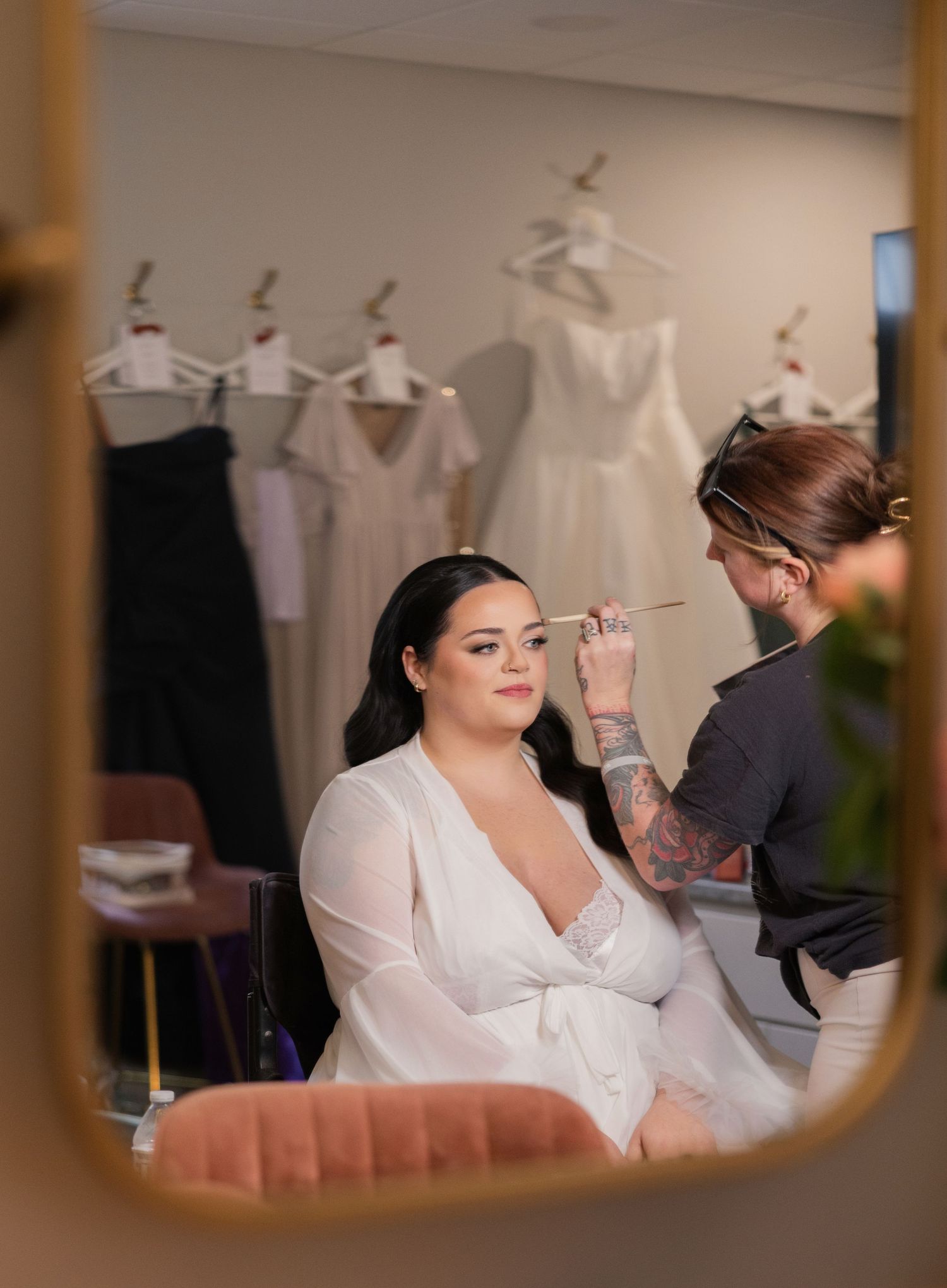 Hair styling session in progress with professional tools and bright window lighting. Ohio Bride.